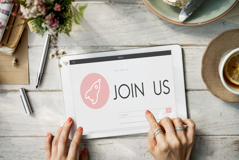 Someone uses a tablet to submit a website sign up form