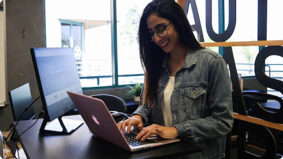 Elika smiling at laptop